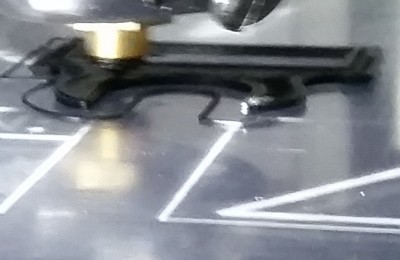 Here is the first print zoomed in. It looks like the front right edge is slightly off the bed. Should this be flat?